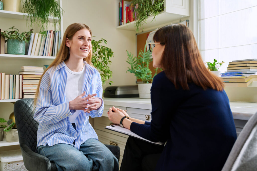 behavioral health therapist discussing with smiling teenage girl about finding OCD treatment for teens in Pasadena, CA