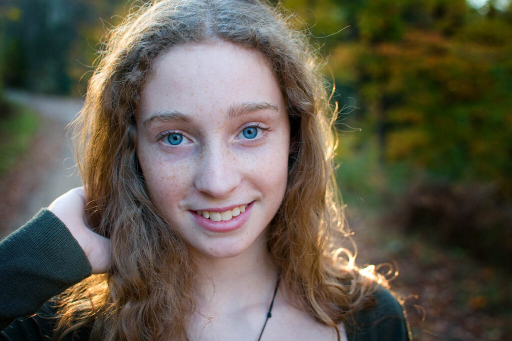 smiling teenage girl is confident in her ability to recognize common signs of ADHD in herself and others