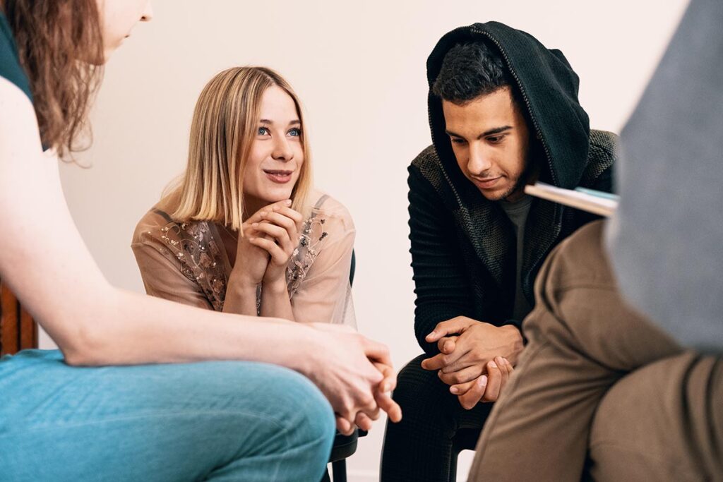 Several teens in group therapy for teens