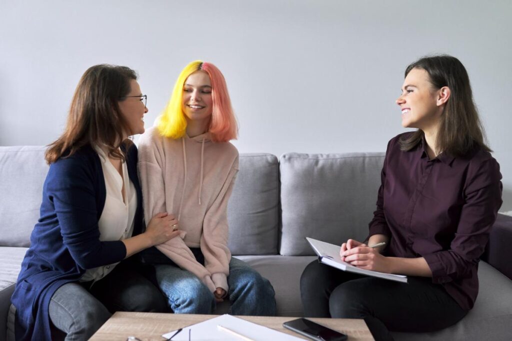 therapist explaining to mother and daughter about adolescent self-harm and what parents need to know